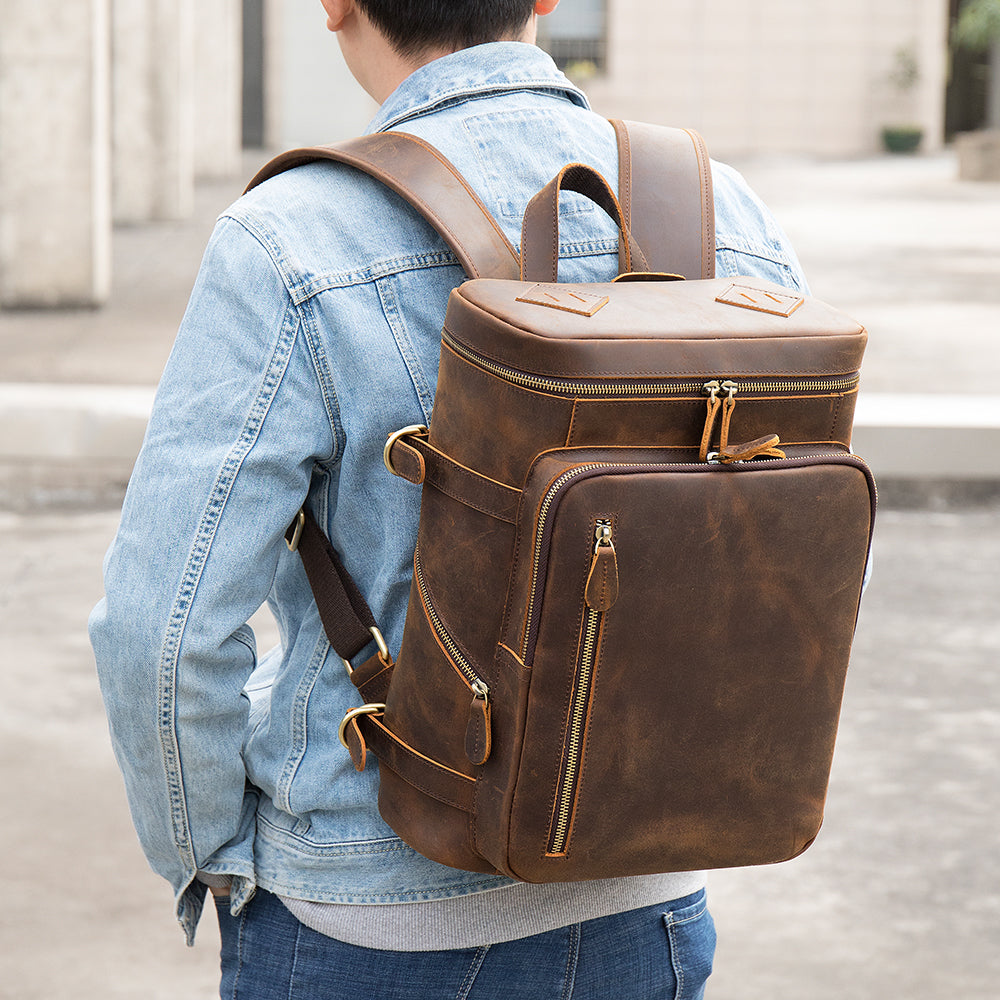 Man wearing the Velavio Vintage brown crazy horse leather backpack with a denim jacket