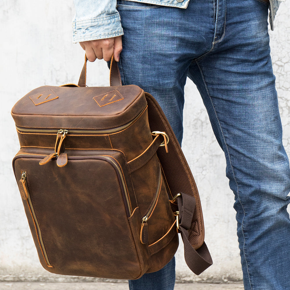 Velavio Vintage brown leather backpack carried by the top handle