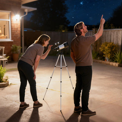 Couple using the telescope on a patio at night
