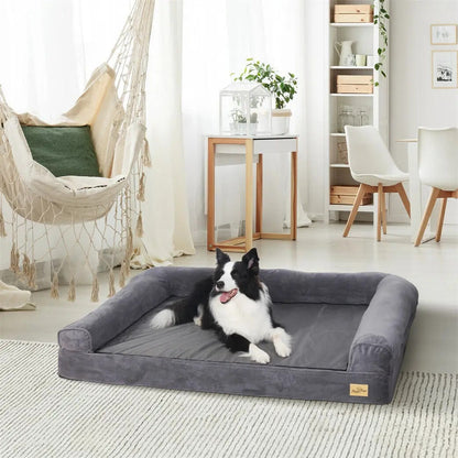 Orthopedic dog couch bed in gray with a dog lying on it