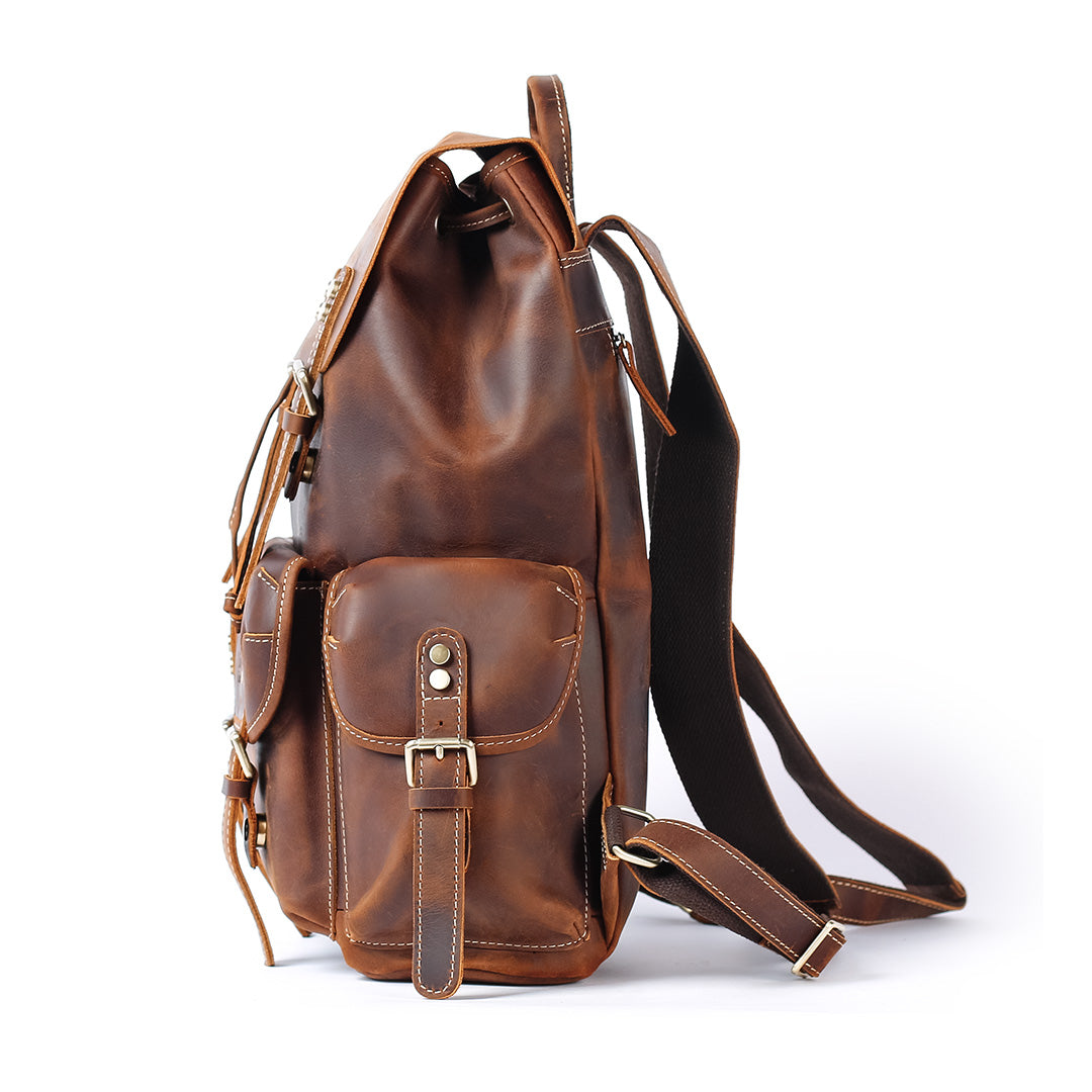 Brown leather backpack with a strap on a white background