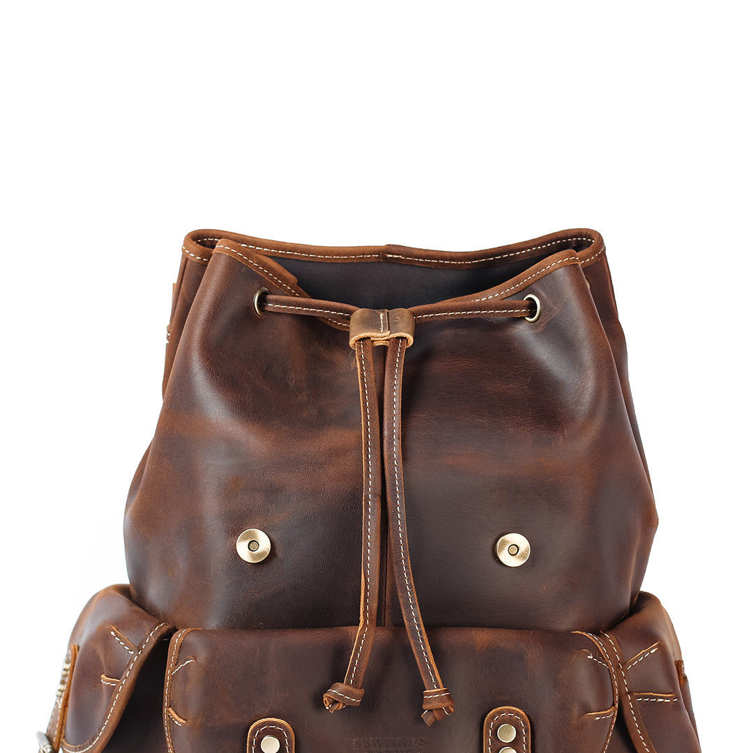 Brown leather backpack with drawstring on a white background