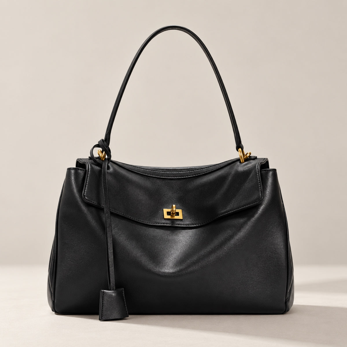 Kensington soft leather shoulder bag in black with gold twist-lock, front view