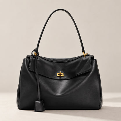 Kensington soft leather shoulder bag in black with gold twist-lock, front view