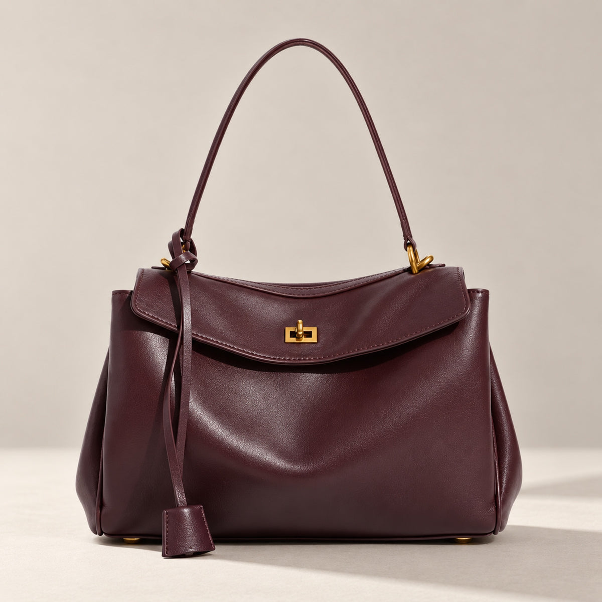 Kensington leather shoulder bag in burgundy with gold twist-lock