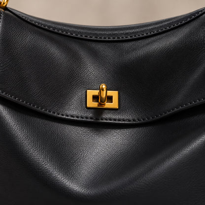 Close-up of the gold twist-lock and stitched flap on the Kensington leather bag