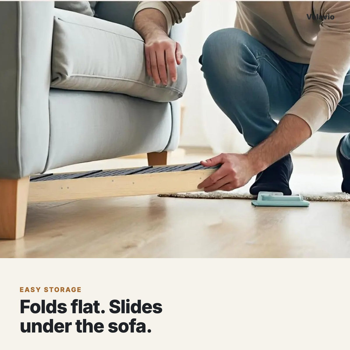 Folded dog ramp sliding under a sofa for storage